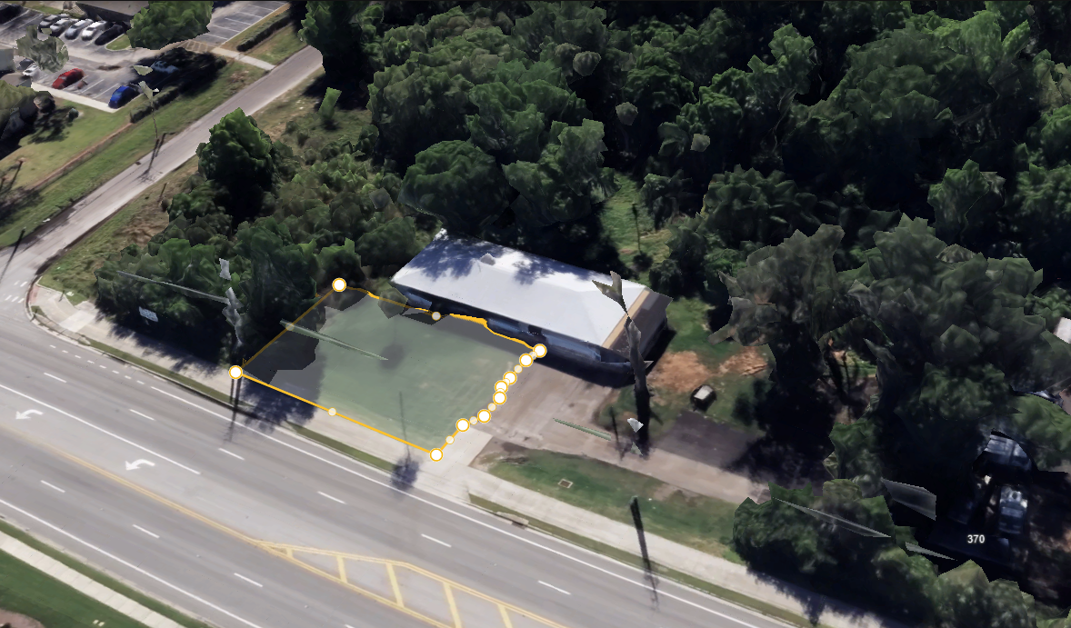 Aerial view of a residential property with lawn, driveway, and pool